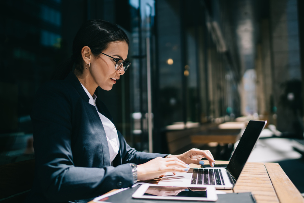 Side,View,Of,Serious,Female,Economist,Working,Online,With,Accounting